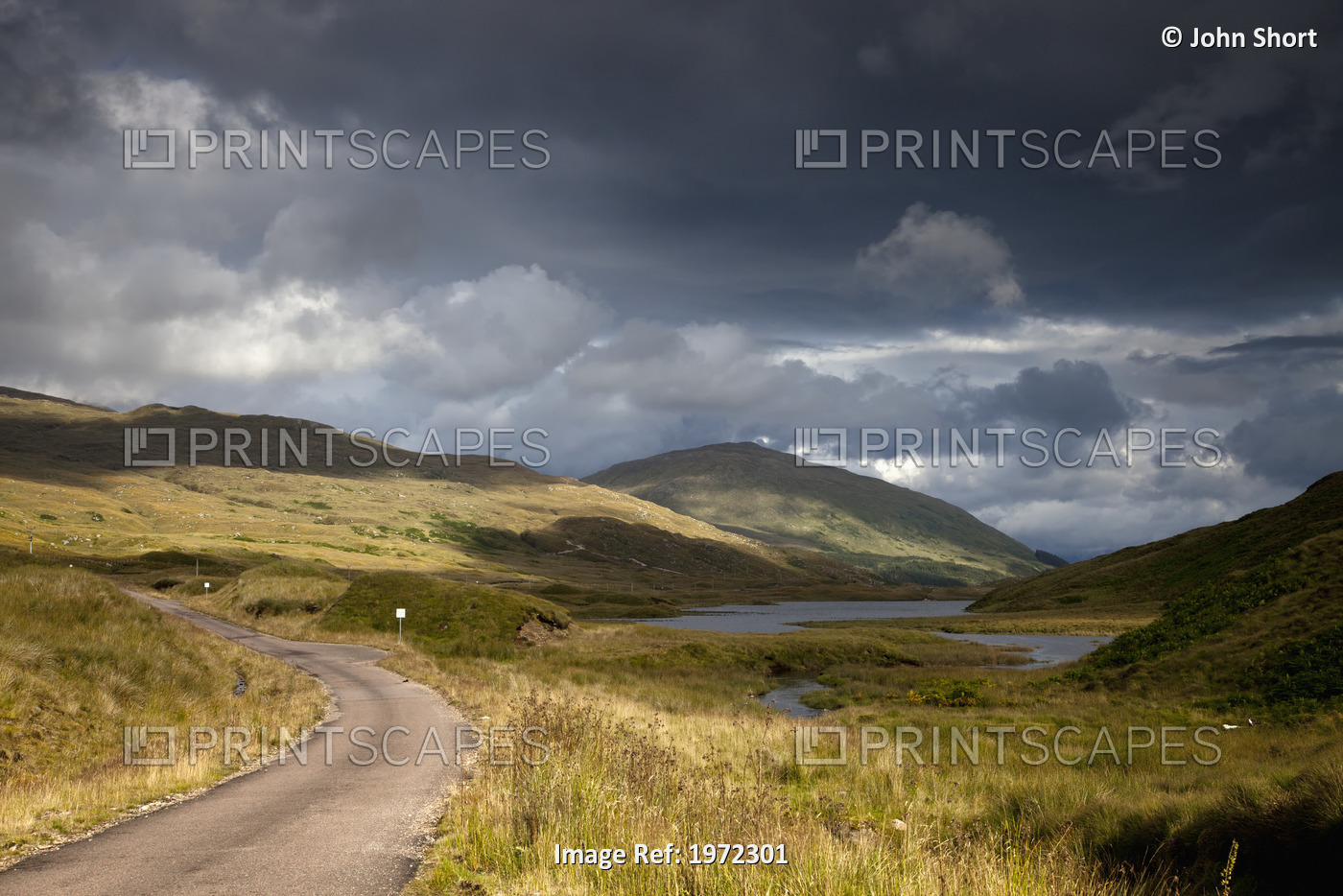 A Road Curving Through A Mountainous Landscape; Ardnamurchan, Argyl,Scotland