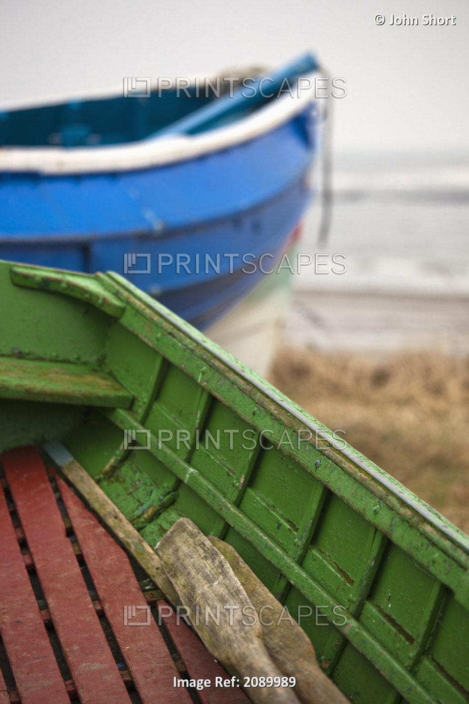 Paddles in a colourful wooden rowboat on the shore;Boulmer northumberland ...