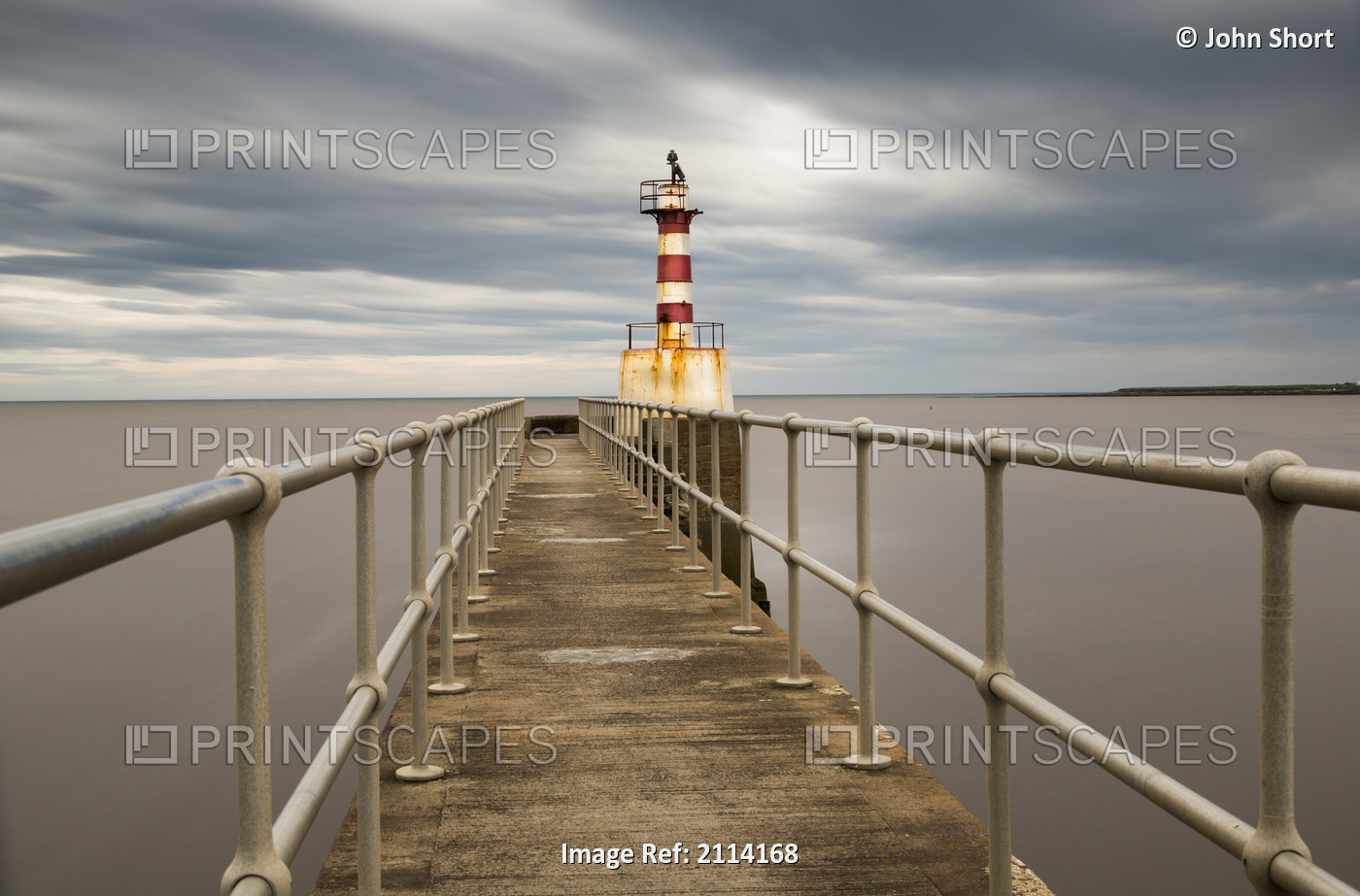 A Red And White Striped Lighthouse At The End Of A Pier; Amble Northumberland ...