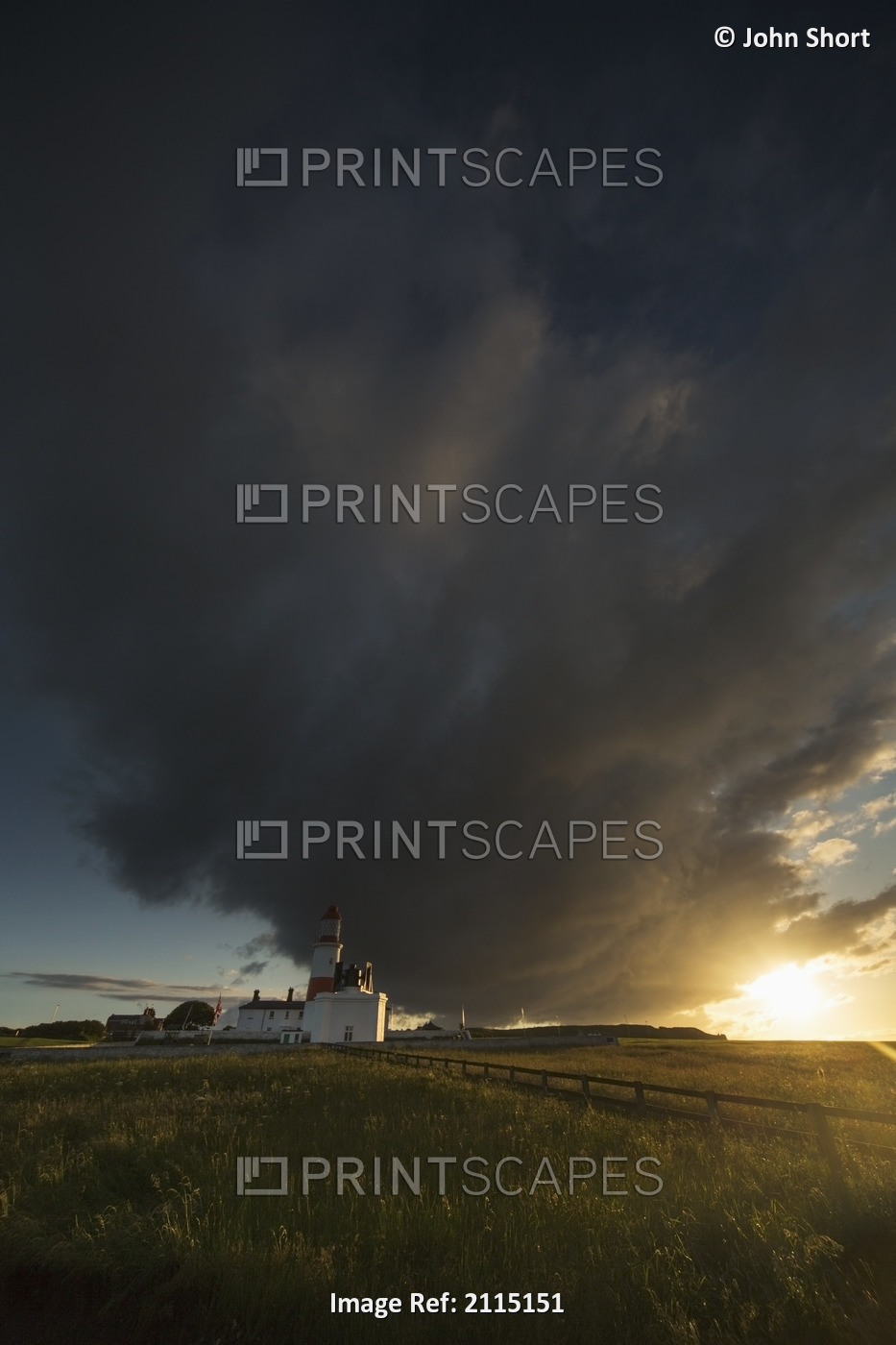 Storm cloud formation over a lighthouse at sunset;South shields tyne and wear ...