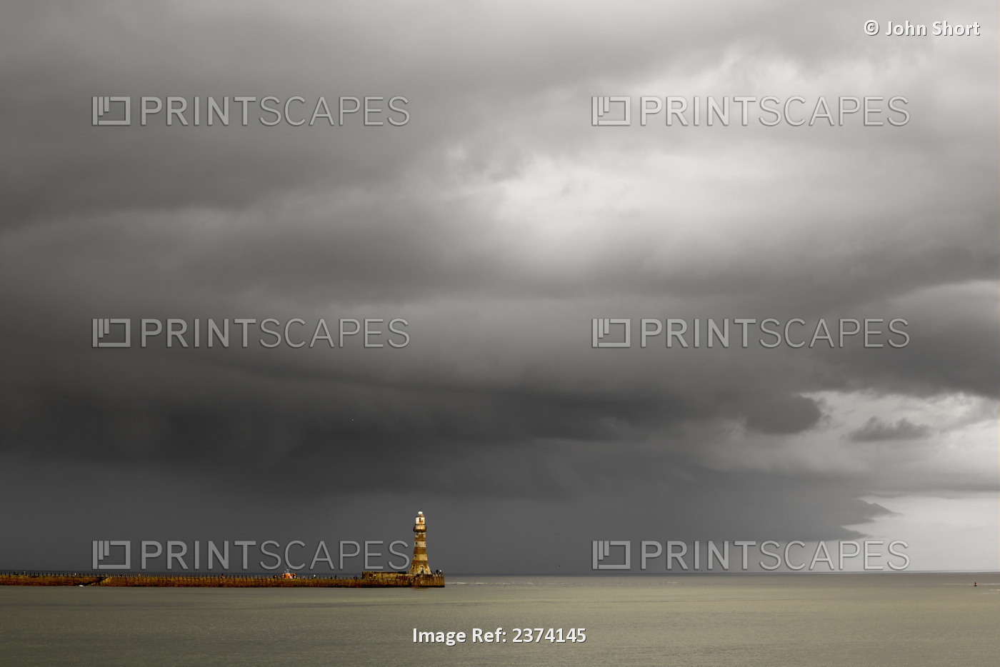 Lighthouse At The End Of A Pier With Dark Storm Clouds Overhead; Sunderland, ...