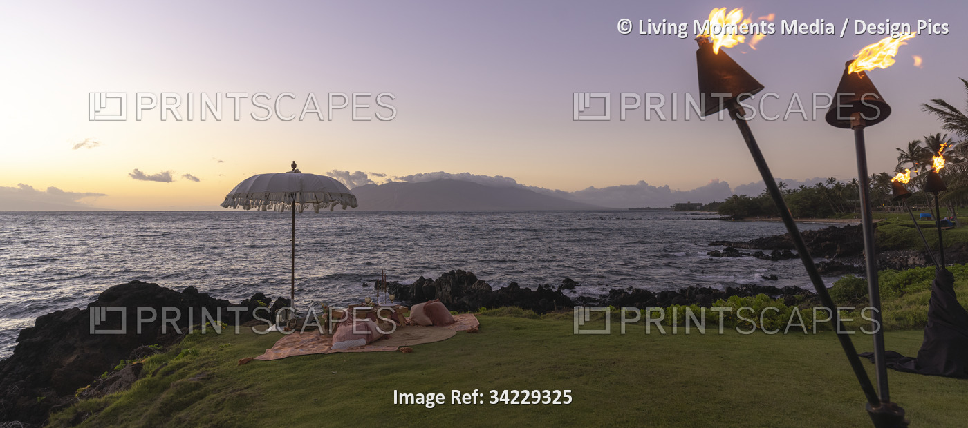 Picnic at sunset along the coast of a Hawaiian island, USA; Maui, Hawaii, ...