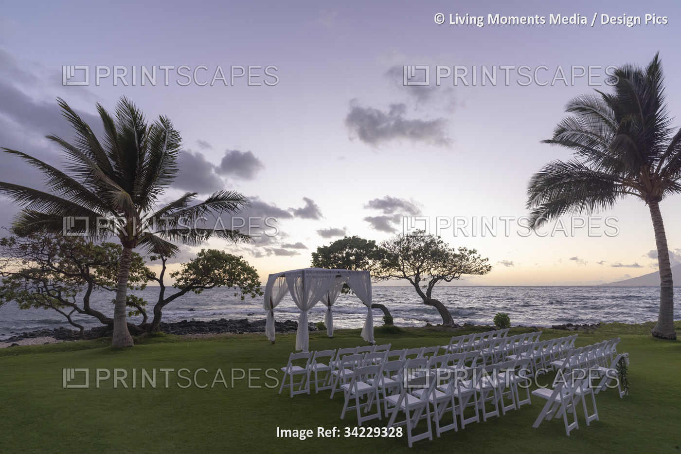Set-up for an outdoor wedding at sunset along the coast of a hawaiian island ...